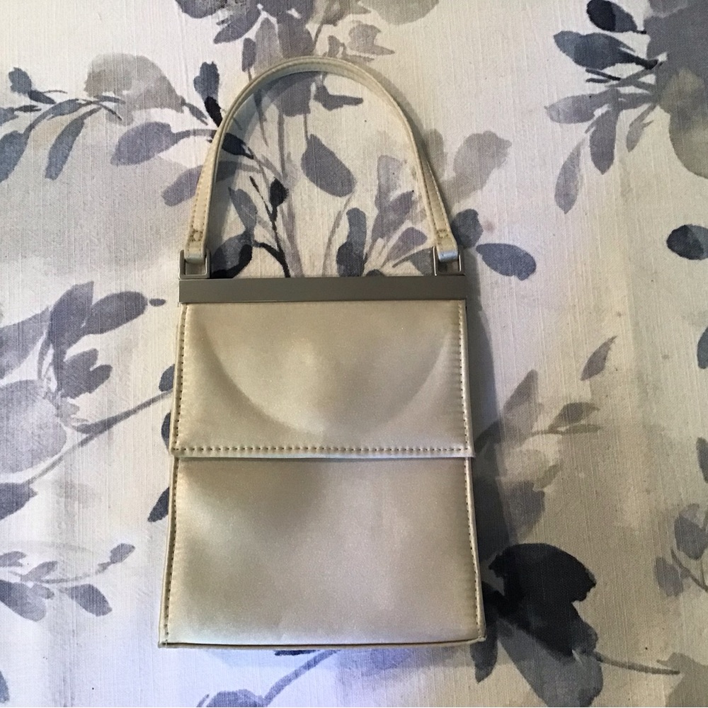 Nine West mini evening bag. Cream satin with silver metal bar.Snap front…